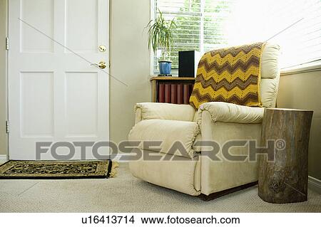 Throw blanket on armchair in domestic room View Large Photo Image Picture - Throw blanket on armchair in domestic room. Fotosearch