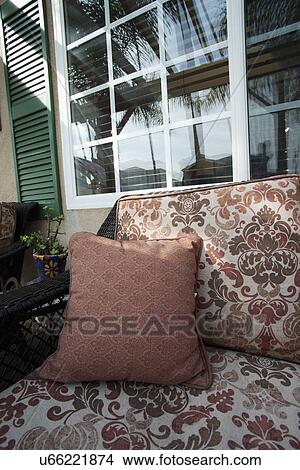 Throw pillow on patio chair View Large Photo Image Picture - Throw pillow on patio chair. Fotosearch