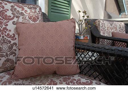 Throw pillow on patio chair View Large Photo Image Stock Image - Throw pillow on patio chair. Fotosearch