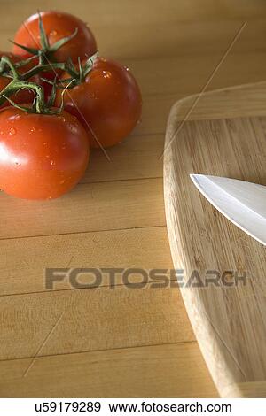 Tomatoes and cutting board on counter; Carpinteria; California; USA View Large Photo Image Stock Photo - Tomatoes and cutting board on counter; Carpinteria; California; USA. Fotosearch