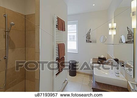 Stock Photo - Towel warmer and shower in domestic bathroom. Fotosearch