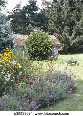 Toy tractor on grass outside barn View Large Photo Image Picture - Toy tractor on grass outside barn. Fotosearch