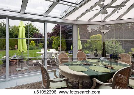Stock Photograph - Traditional dining table in sunroom. Fotosearch