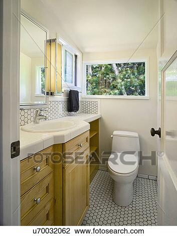 Stock Image - Traditional half bath with white tile. Fotosearch