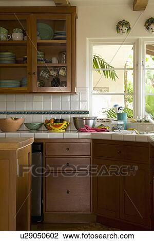 Stock Image - Traditional kitchen with brown cabinets; Carpinteria; California; USA. Fotosearch