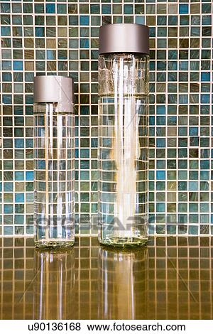 Two jars of water on countertop in front of mosaic tile backsplash; Ontario; California; USA View Large Photo Image Stock Photo - Two jars of water on countertop in front of mosaic tile backsplash; Ontario; California; USA. Fotosearch