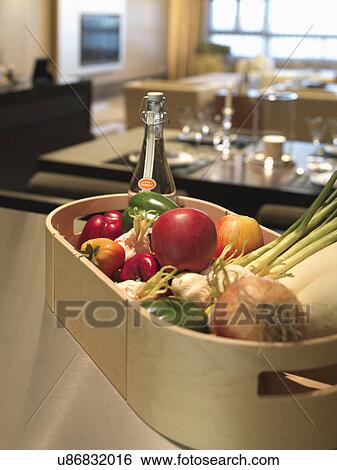 Vegetables, fruits and bottle in wooden tray on table View Large Photo Image Stock Photograph - Vegetables, fruits and bottle in wooden tray on table. Fotosearch