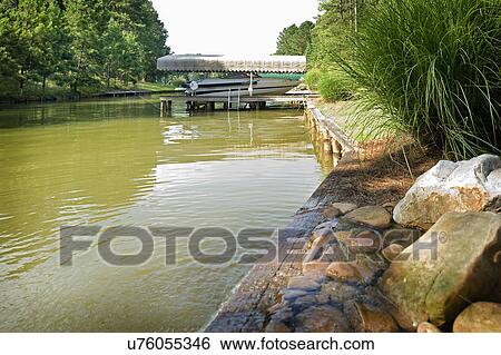 View of a boat moored under shade in river View Large Photo Image Stock Photograph - View of a boat moored under shade in river. Fotosearch