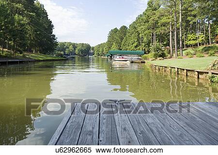 Stock Photography - View of a moored boat seen from the boardwalk. Fotosearch