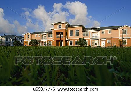 View of apartment complex from grass View Large Photo Image Stock Photograph - View of apartment complex from grass. Fotosearch