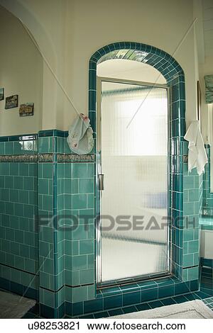 Stock Image - Walk-in shower with glass door; Carpinteria; California; USA. Fotosearch