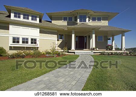Stock Image - Walkway leading to the entrance of single family home. Fotosearch