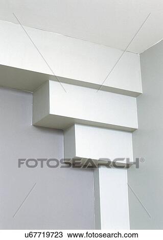 Stock Image - Wall with white column and stacked rectangular shapes at top connecting to ceiling. Fotosearch