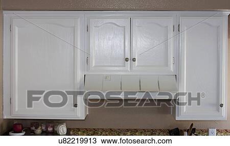 Stock Image - White cabinets and vent in kitchen, Laguna Beach, California, USA. Fotosearch
