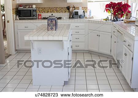 White monochromatic traditional kitchen with island, Laguna Beach, California, USA View Large Photo Image Stock Image - White monochromatic traditional kitchen with island, Laguna Beach, California, USA. Fotosearch