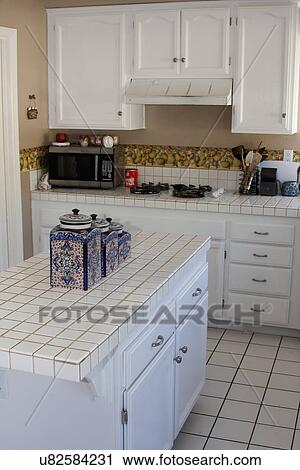 White monochromatic traditional kitchen with island, Laguna Beach, California, USA View Large Photo Image Stock Image - White monochromatic traditional kitchen with island, Laguna Beach, California, USA. Fotosearch
