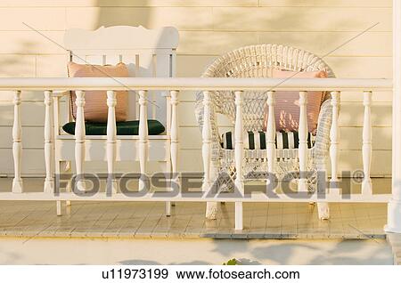 Stock Photo - Wick chair on front porch, Grand Isle, Vermont, USA. Fotosearch