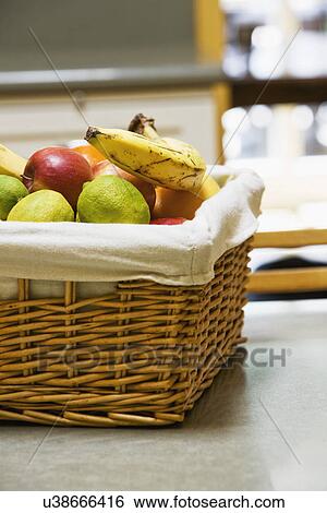 Wicker basket full of fruit View Large Photo Image Stock Photograph - Wicker basket full of fruit. Fotosearch
