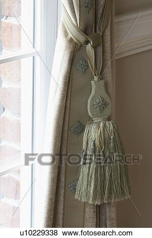 Window Treatment Detail Is Tassel Hanging From Drapery Holdback