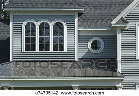 Stock Image - Window with shingled roof in single family home. Fotosearch