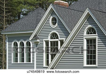 Stock Photo - Window with shingled roof in single family home. Fotosearch