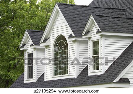 Picture - Window with shingled roof of single family home. Fotosearch