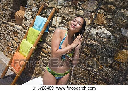 Woman enjoying outdoor shower, Mykonos, Greece View Large Photo Image Stock Photo - Woman enjoying outdoor shower, Mykonos, Greece. Fotosearch