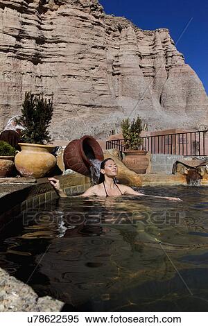 Stock Photography - Woman in hot tub in the southwest. Fotosearch