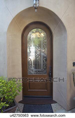 Stock Image - Wooden and glass front door of contemporary home, Laguna Beach, California, USA. Fotosearch
