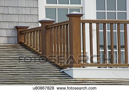 Stock Photo - Wooden balcony railing and shingled roof. Fotosearch