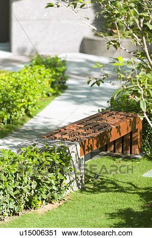 Wooden bench in a park View Large Photo Image Stock Image - Wooden bench in a park. Fotosearch