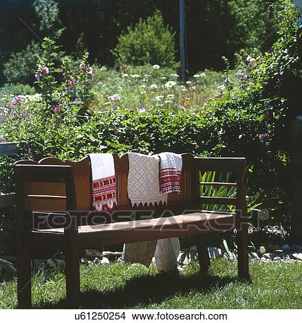 Wooden bench in botanical garden View Large Photo Image Picture - Wooden bench in botanical garden. Fotosearch
