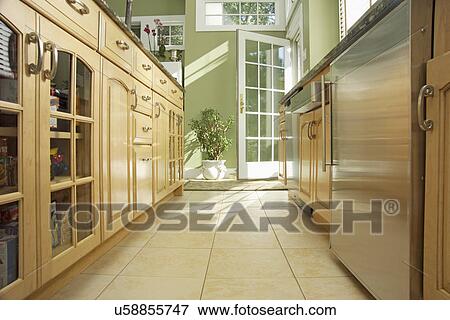 Stock Photo - Wooden cabinets in domestic kitchen. Fotosearch