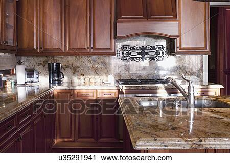 Wooden cabinets in traditional kitchen, Laguna Beach, California, USA View Large Photo Image Stock Image - Wooden cabinets in traditional kitchen, Laguna Beach, California, USA. Fotosearch
