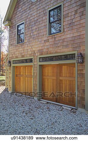 Stock Photo - Wooden doors at garage of single family home. Fotosearch