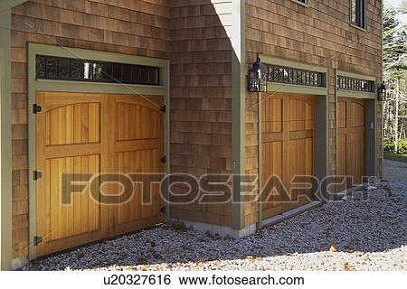 Stock Photograph - Wooden doors at garage of single family home. Fotosearch
