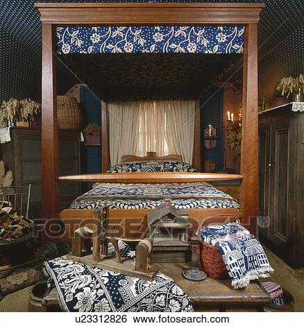 Wooden four-poster canopy bed in bedroom View Large Photo Image Stock Photograph - Wooden four-poster canopy bed in bedroom. Fotosearch