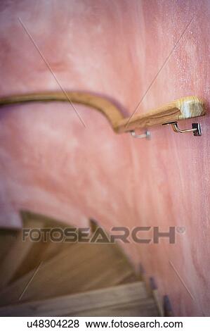 Stock Photo - Wooden handrail along curved staircase. Fotosearch