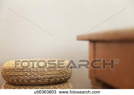 Stock Image - Woven floor mats stacked against wall; Burbank; California; USA. Fotosearch