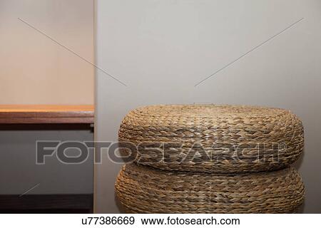 Stock Photo - Woven floor mats stacked against wall; Burbank; California; USA. Fotosearch