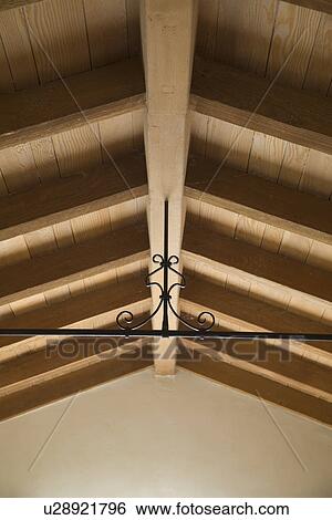 Stock Photograph - Wrought iron beam supporting wooden ceiling; Carpinteria; California; USA. Fotosearch