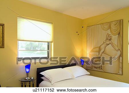 Stock Image - Yellow bedroom with blue lamps; Lincoln; Nebraska; USA. Fotosearch