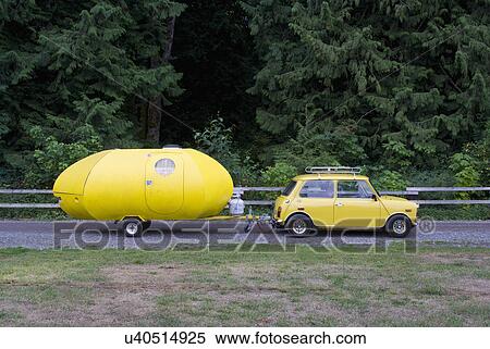 Stock Photography - Yellow car pulling a yellow trailer; Yakima; Washington; USA. Fotosearch