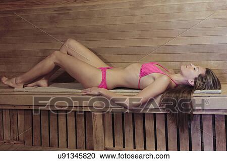 Young woman in a pink bikini lying on back at sauna View Large Photo Image Stock Image - Young woman in a pink bikini lying on back at sauna. Fotosearch
