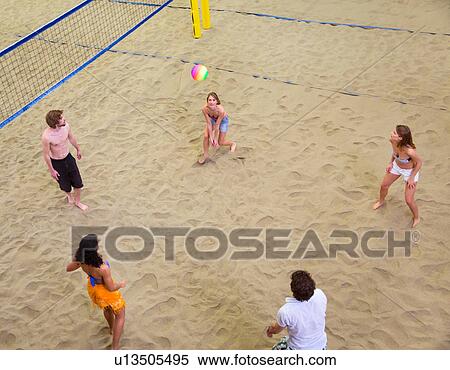 Aerial view of friends playing indoor beach volleyball View Large Photo Image Stock Photography - Aerial view of friends playing indoor beach volleyball. Fotosearch