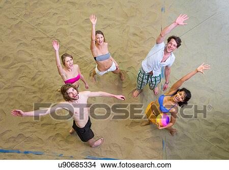 Aerial view of friends waving at indoor beach volleyball View Large Photo Image Picture - Aerial view of friends waving at indoor beach volleyball. Fotosearch