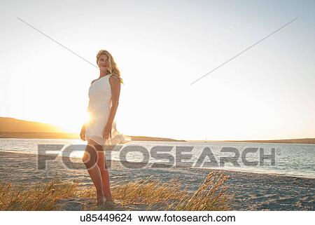 Blond woman posing on beach at dusk, Cape Town, South Africa View Large Photo Image Picture - Blond woman posing on beach at dusk, Cape Town, South Africa. Fotosearch