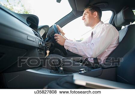 Businessman driving in car View Large Photo Image Stock Photo - Businessman driving in car. Fotosearch