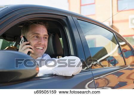 Businessman talking on mobile in his car View Large Photo Image Stock Photo - Businessman talking on mobile in his car. Fotosearch