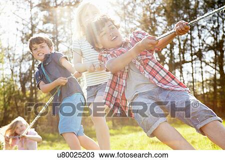 Stock Image - Children playing tug o war. Fotosearch